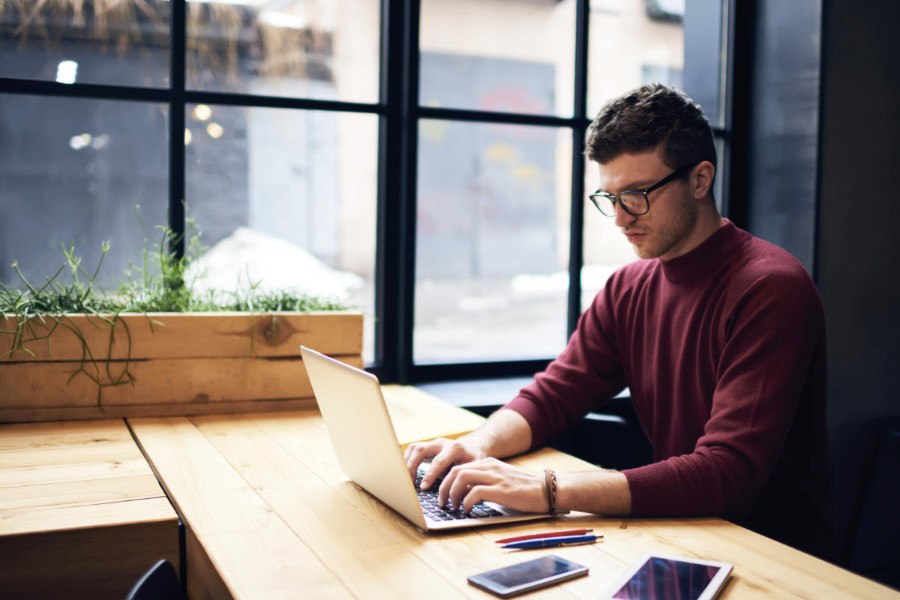 social media manager working on his laptop
