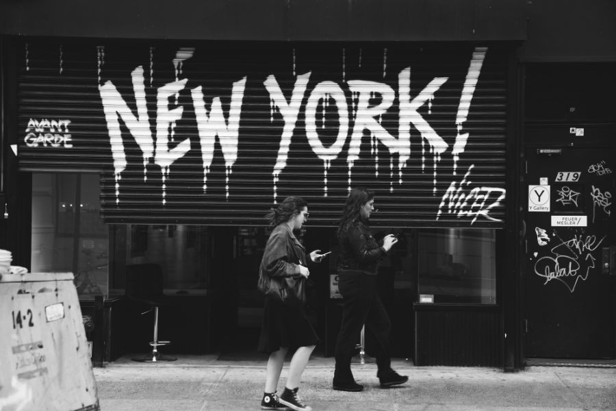 shop in NYC, with New York painted on rolling shutter