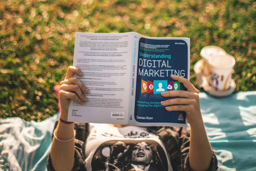 a person reading a book about digital marketing