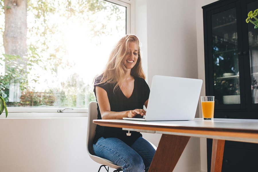 woman creating a digital marketing resume on her laptop