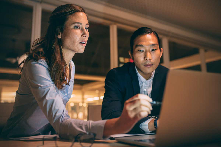 social media manager creating portfolio with help from a coworker